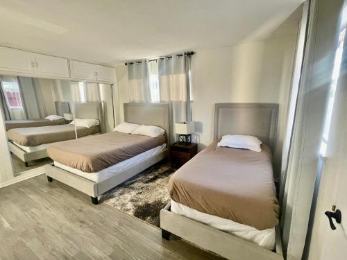 two beds in a room with two beds sidx sidx sidx sidx at Glendora Pool Home Retreat in Glendora