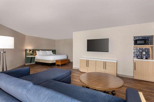 a living room with a couch and a bed at Hilton Garden Inn Monterey in Monterey