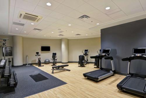 a gym with treadmills and exercise bikes in a room at Embassy Suites by Hilton Minneapolis Airport in Bloomington