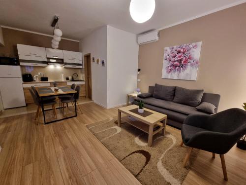 a living room with a couch and a table at Apartment and rooms Corina in Bilje