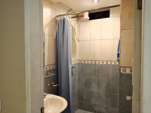 a bathroom with a shower and a sink at Tin House Quito in Quito