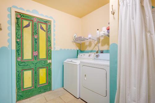a laundry room with a washing machine and a green door at Beautiful Española Retreat with Patio! in Espanola