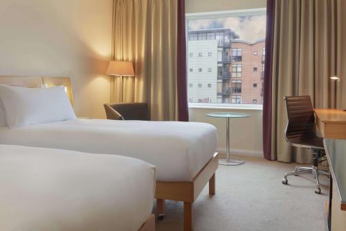 a hotel room with two beds and a window at Hilton Newcastle Gateshead in Newcastle upon Tyne
