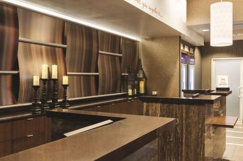 a bar in a hotel lobby with a counter at Hilton Garden Inn New York Manhattan Midtown East in New York