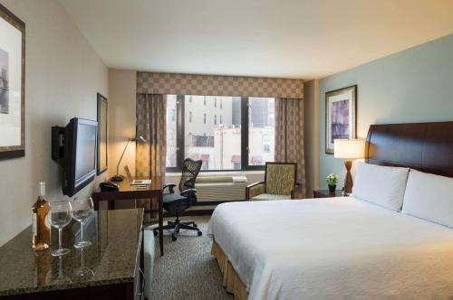 a hotel room with a bed and a desk at Hilton Garden Inn New York/Tribeca in New York