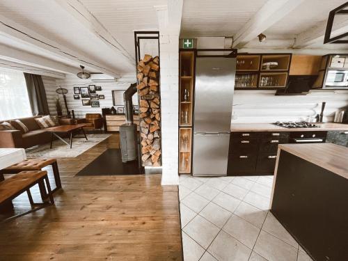 a kitchen and living room with a refrigerator and a table at HYTTE - Cozy Stay For Families & Friends 