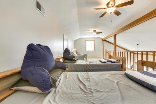 a bedroom with two beds and a ceiling fan at Bayou Bliss Barataria Waterfront Getaway with Dock! in Barataria