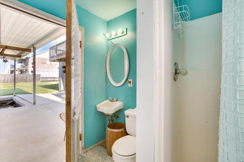 a bathroom with a toilet and a mirror at Bayou Bliss Barataria Waterfront Getaway with Dock! in Barataria