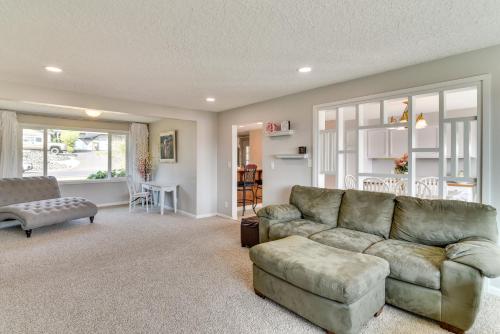 a living room with a couch and a table at Serene Forest Grove Home with Deck and Stunning Views! in Forest Grove