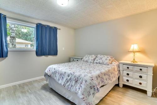 a bedroom with a bed and a window at Serene Forest Grove Home with Deck and Stunning Views! in Forest Grove