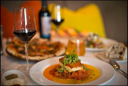 a table with a plate of food and a glass of wine at Signia by Hilton Orlando - An Official Walt Disney World Hotel in Orlando