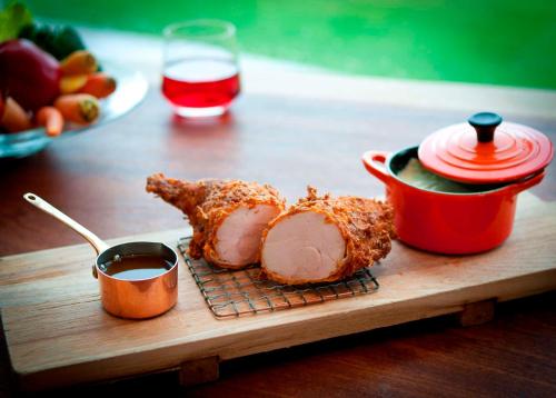 a cutting board with meat and sauce on a table at Signia by Hilton Orlando - An Official Walt Disney World Hotel in Orlando