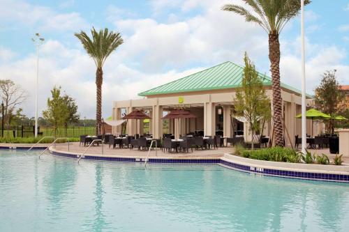 a pool at a resort with palm trees at Signia by Hilton Orlando - An Official Walt Disney World Hotel in Orlando