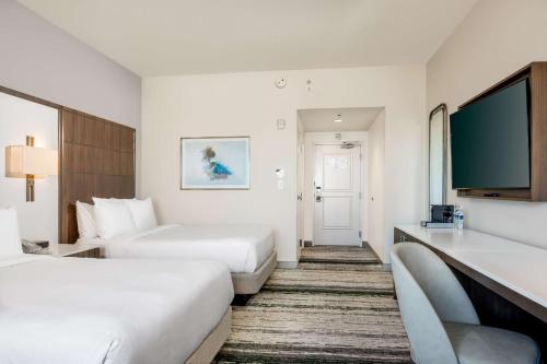 a hotel room with two beds and a flat screen tv at Signia by Hilton Orlando - An Official Walt Disney World Hotel in Orlando