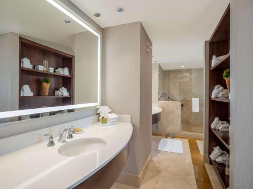 a bathroom with a sink and a large mirror at Signia by Hilton Orlando - An Official Walt Disney World Hotel in Orlando