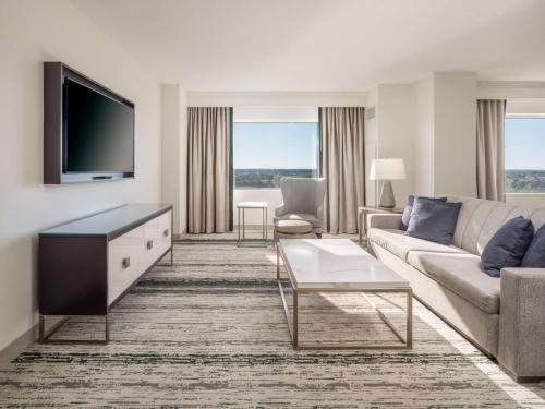 a living room with a couch and a tv at Signia by Hilton Orlando - An Official Walt Disney World Hotel in Orlando