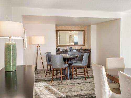 a dining room and living room with a table and chairs at Signia by Hilton Orlando - An Official Walt Disney World Hotel in Orlando