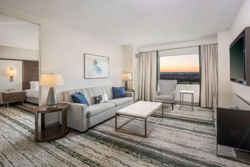 a living room with a couch and a tv at Signia by Hilton Orlando - An Official Walt Disney World Hotel in Orlando