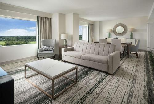 a living room with a couch and a table at Signia by Hilton Orlando - An Official Walt Disney World Hotel in Orlando