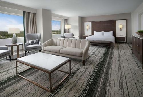 a hotel room with a bed and a couch and a table at Signia by Hilton Orlando - An Official Walt Disney World Hotel in Orlando
