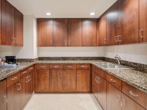a kitchen with wooden cabinets and a sink at Signia by Hilton Orlando - An Official Walt Disney World Hotel in Orlando