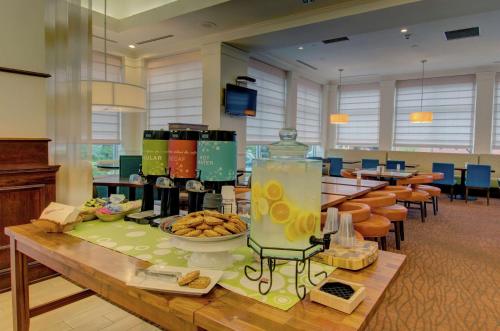 a lobby with a table with food on it at Hilton Garden Inn Norwalk in Norwalk