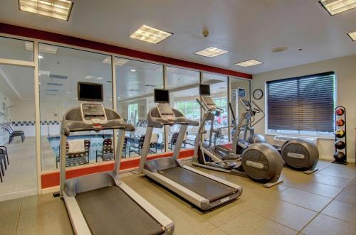 a gym with treadmills and elliptical machines at Hilton Garden Inn Norwalk in Norwalk