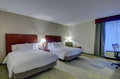 a hotel room with two beds and a window at Hilton Garden Inn Norwalk in Norwalk