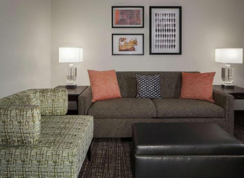 a living room with a couch and a chair at Embassy Suites by Hilton Philadelphia Airport in Philadelphia