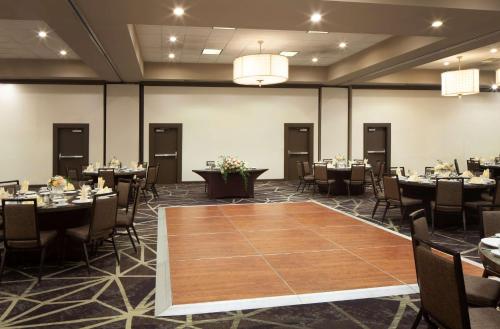 a banquet room with tables and chairs and a large table at Embassy Suites by Hilton Philadelphia Airport in Philadelphia