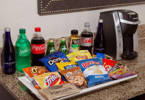 a tray of food and drinks on a counter with soda at Embassy Suites by Hilton Philadelphia Airport in Philadelphia