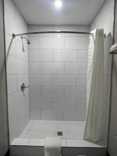 a bathroom with a shower with a shower curtain at Vance Motel in Lynwood