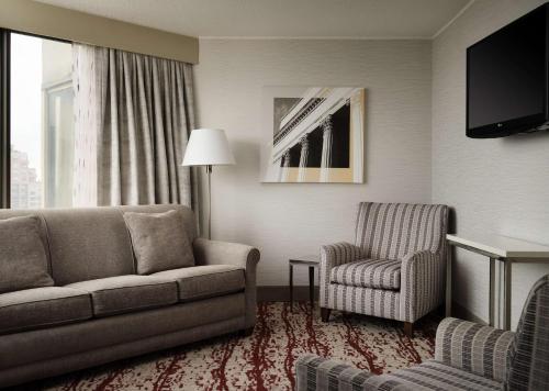 a living room with a couch and a chair at DoubleTree by Hilton Hotel Philadelphia Center City in Philadelphia