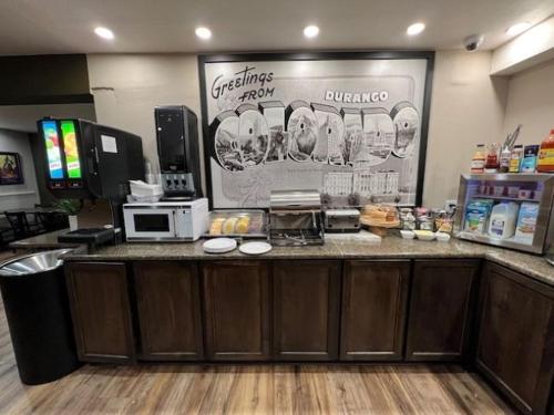 a coffee shop with a counter in a store at Super 8 by Wyndham Durango in Durango