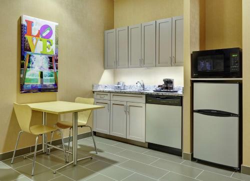 a small kitchen with a table and a microwave at DoubleTree by Hilton Hotel Philadelphia Center City in Philadelphia