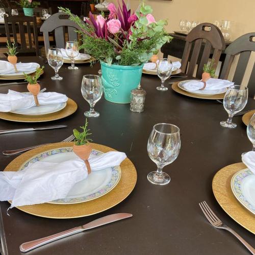 a black table with plates and wine glasses on it at Pousada Nascente do Pirahy in Piraí