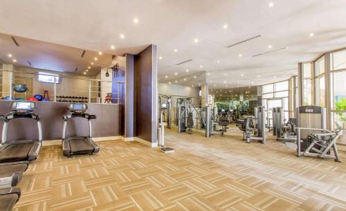 a gym with treadmills and machines in a room at Waldorf Astoria Panama in Panama City