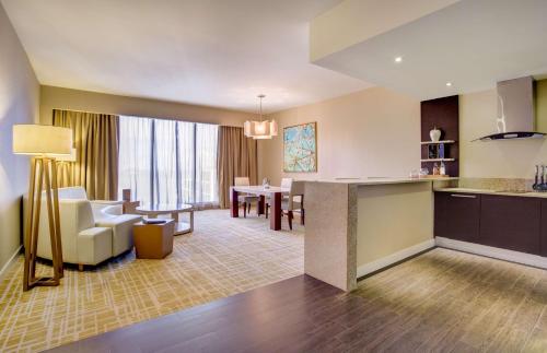 a hotel room with a kitchen and a living room at Waldorf Astoria Panama in Panama City