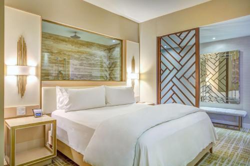 a bedroom with a large white bed and a window at Waldorf Astoria Panama in Panama City