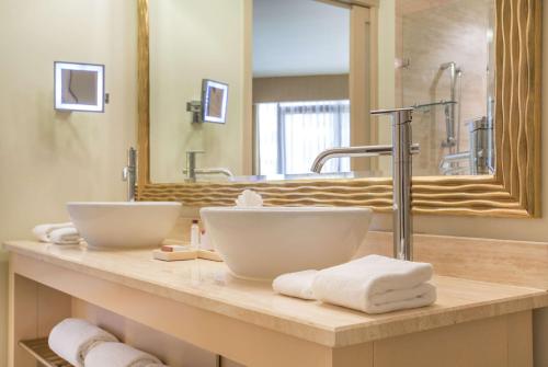 a bathroom counter with two sinks and a mirror at Waldorf Astoria Panama in Panama City