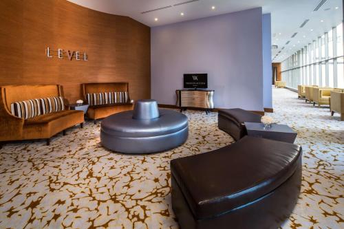 a lobby with a waiting area with a couch and chairs at Waldorf Astoria Panama in Panama City
