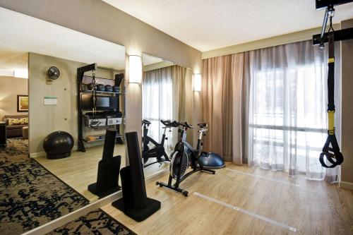 a hotel room with a gym with exercise equipment at Embassy Suites by Hilton Raleigh Durham Research Triangle in Cary