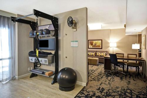 a living room with a room with a table and a couch at Embassy Suites by Hilton Raleigh Durham Research Triangle in Cary