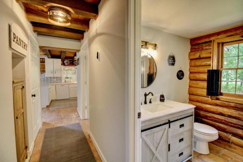 a bathroom with a sink and a toilet at Unplug and Recharge: Bayou Log Cabin Retreat in Dickinson