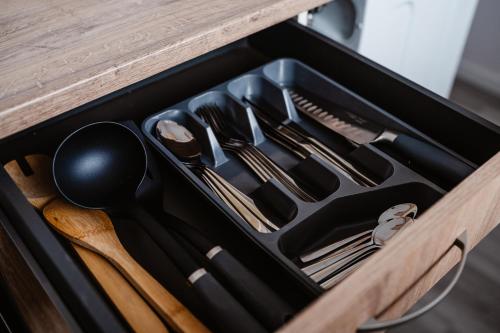 a drawer filled with utensils on a table at Apartmán Nová Nemocnica 10min. pešo do Centra in Košice