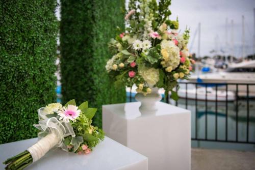 a white vase filled with flowers on a table at Hilton San Diego Airport/Harbor Island in San Diego