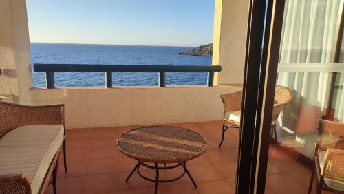 a balcony with a table and chairs and the ocean at Club Playa Blanca in Playa Blanca