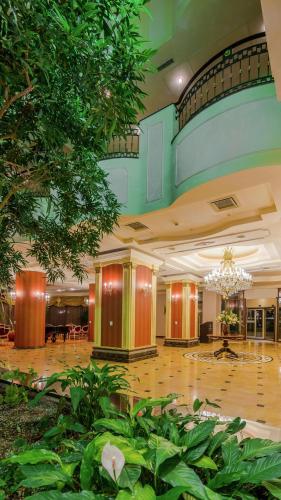 a large lobby with a large building with a chandelier at Hilton Sibiu in Sibiu