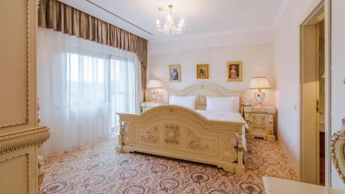 a bedroom with a large bed and a chandelier at Hilton Sibiu in Sibiu