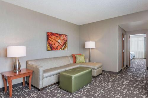 a living room with a couch and a table at Embassy Suites by Hilton Saint Louis Saint Charles in St. Charles
